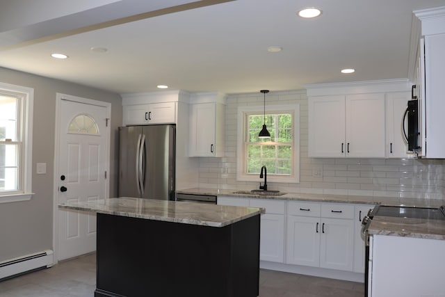 197 New Rd, Tolland, CT 06084 - kitchen with stainless steel appliances, a baseboard heating unit, a sink, light stone counters, and backsplash