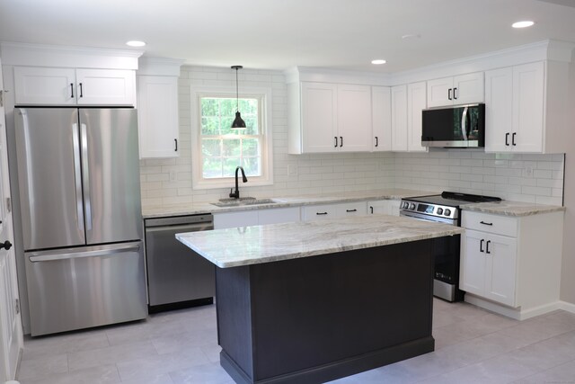 197 New Rd, Tolland, CT 06084 - kitchen featuring appliances with stainless steel finishes, a sink, backsplash, light stone counters, and recessed lighting