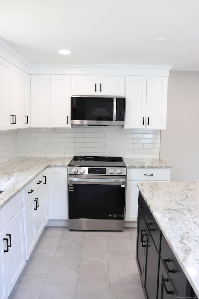 197 New Rd, Tolland, CT 06084 - kitchen featuring stainless steel appliances, backsplash, white cabinetry, and light stone counters