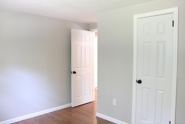 197 New Rd, Tolland, CT 06084 - unfurnished bedroom with dark wood-style floors and baseboards