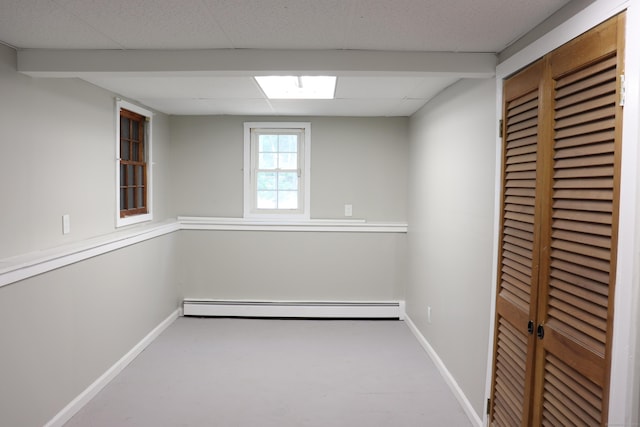197 New Rd, Tolland, CT 06084 - basement with a baseboard heating unit, baseboards, and a drop ceiling
