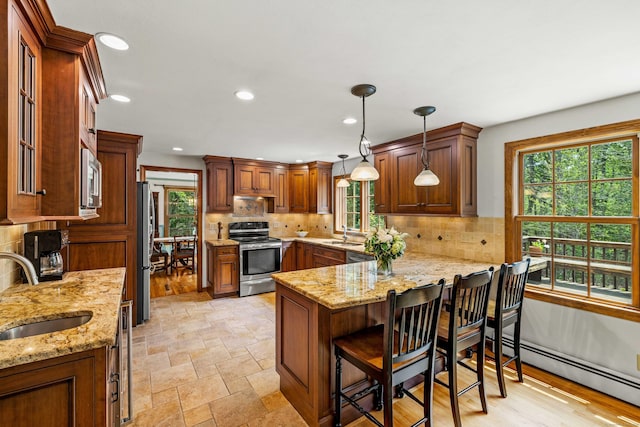 37 Sheffield Ln, Madison, CT 06443 - kitchen featuring stainless steel appliances, baseboard heating, a peninsula, light stone countertops, and recessed lighting