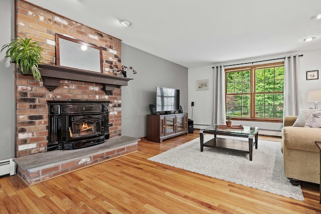37 Sheffield Ln, Madison, CT 06443 - living area featuring wood finished floors, a brick fireplace, and a baseboard radiator