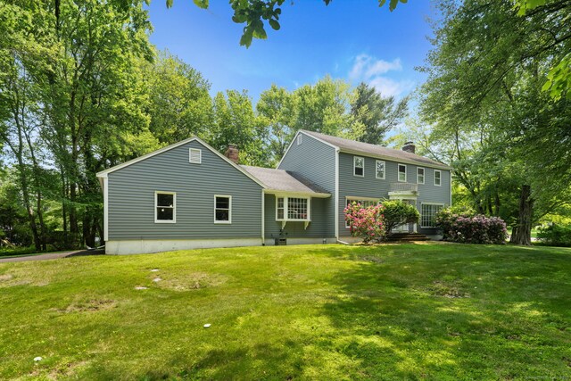 43 Hall Rd, Easton, CT 06612 - rear view of property featuring a chimney, a yard, and roof with shingles