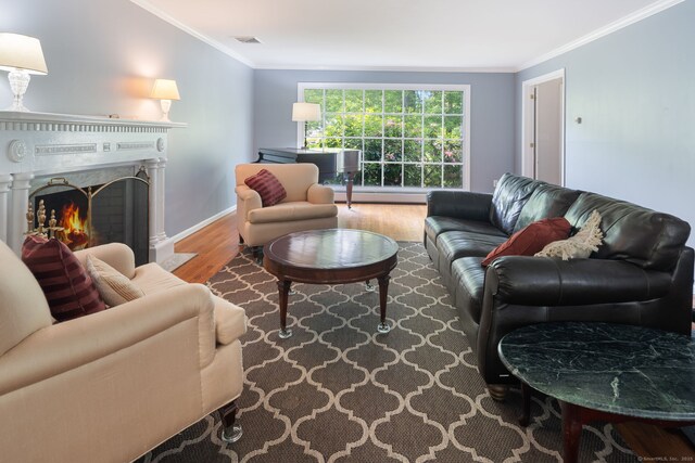 43 Hall Rd, Easton, CT 06612 - living room with wood finished floors, crown molding, and a fireplace with flush hearth