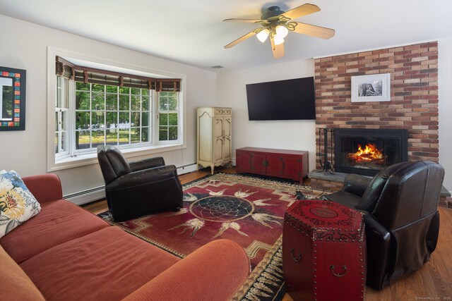 43 Hall Rd, Easton, CT 06612 - living area with wood finished floors, a baseboard radiator, ceiling fan, and a fireplace