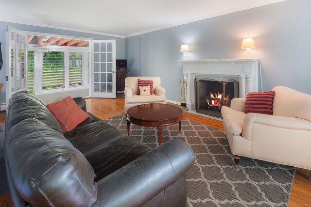 43 Hall Rd, Easton, CT 06612 - living area featuring wood finished floors, crown molding, a fireplace with flush hearth, and ceiling fan