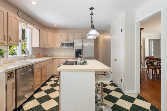 43 Hall Rd, Easton, CT 06612 - kitchen featuring appliances with stainless steel finishes, light floors, a center island, a kitchen bar, and light countertops