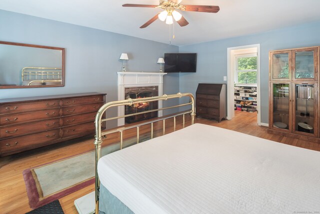 43 Hall Rd, Easton, CT 06612 - bedroom with wood finished floors, a stone fireplace, and ceiling fan