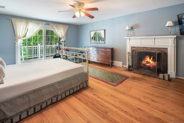 43 Hall Rd, Easton, CT 06612 - bedroom featuring wood finished floors, a fireplace with flush hearth, and ceiling fan