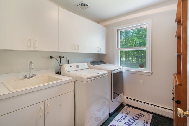 43 Hall Rd, Easton, CT 06612 - laundry area with a baseboard radiator, cabinet space, and washing machine and dryer