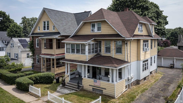 3800 Main St, Stratford, CT 06614 - view of front facade with a porch, roof with shingles, a chimney, and an outbuilding