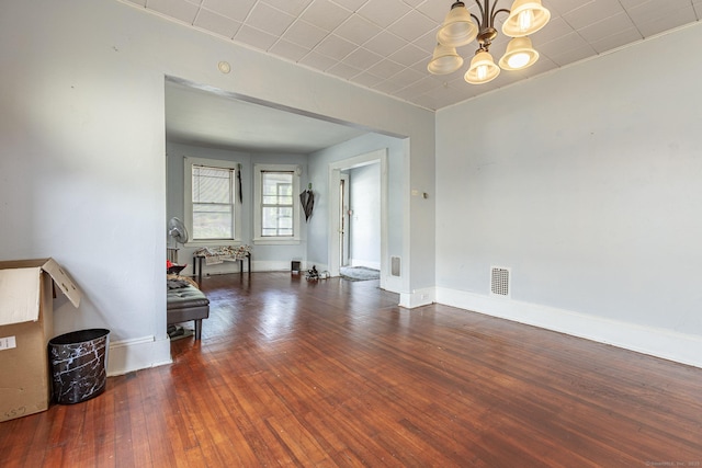 3800 Main St, Stratford, CT 06614 - empty room featuring a chandelier, hardwood / wood-style flooring, and baseboards