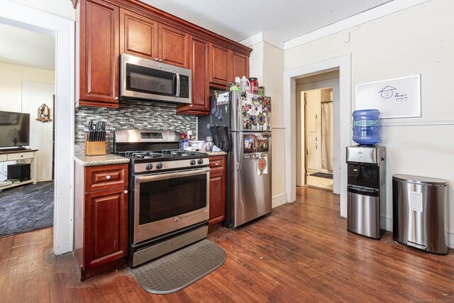 3800 Main St, Stratford, CT 06614 - kitchen with stainless steel appliances, dark wood-type flooring, backsplash, and light stone counters