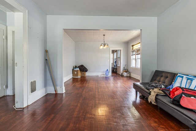 3800 Main St, Stratford, CT 06614 - living room with wood finished floors, a chandelier, and baseboards
