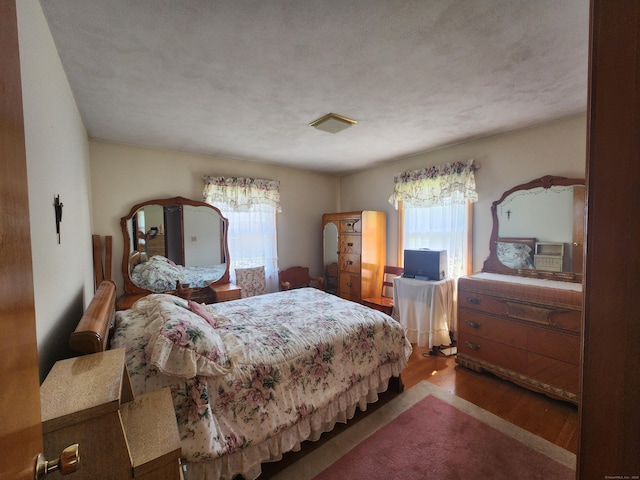 82 Hotchkiss St, Waterbury, CT 06704 - bedroom with multiple windows and wood finished floors