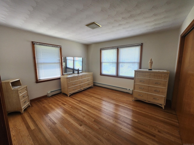 82 Hotchkiss St, Waterbury, CT 06704 - bedroom featuring baseboard heating and wood finished floors