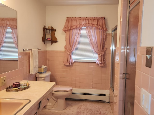 82 Hotchkiss St, Waterbury, CT 06704 - bathroom with tile walls, a baseboard heating unit, vanity, combined bath / shower with glass door, and a wainscoted wall
