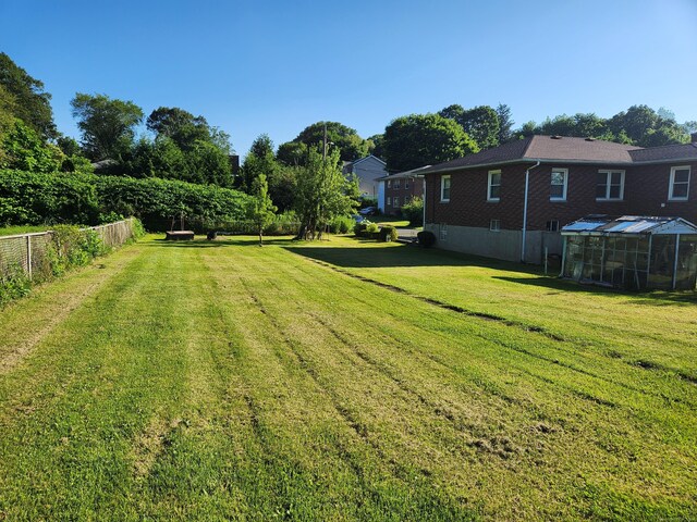 82 Hotchkiss St, Waterbury, CT 06704 - view of yard featuring a greenhouse and an outbuilding