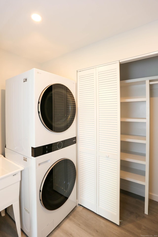 7 Hillcrest Ln, Weston, CT 06883 - washroom featuring stacked washer / dryer, light wood finished floors, and recessed lighting