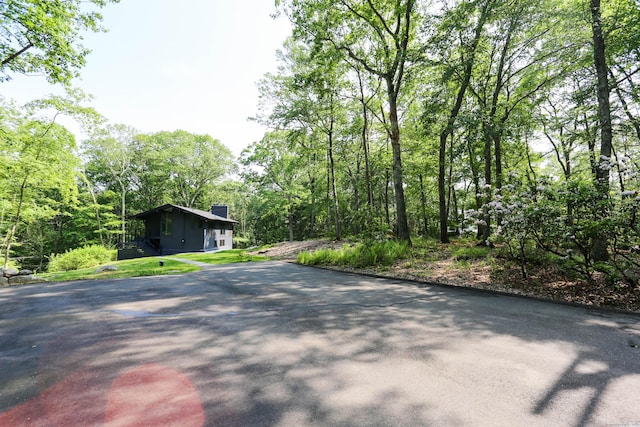 7 Hillcrest Ln, Weston, CT 06883 - view of asphalt driveway featuring a wooded view