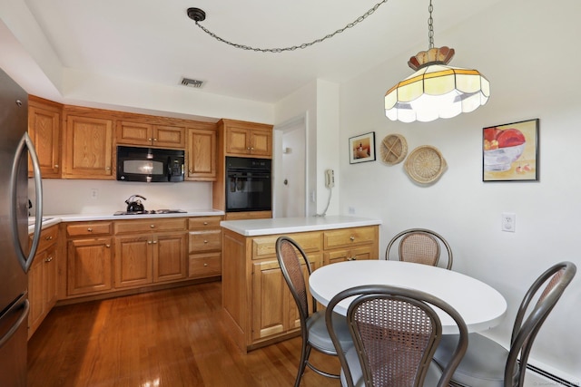 26 Wayfaring Rd, Norwalk, CT 06851 - kitchen featuring black appliances, dark wood-style floors, light countertops, and brown cabinetry