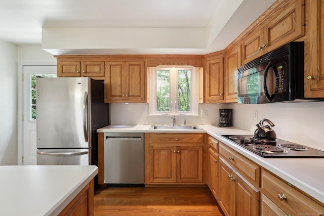 26 Wayfaring Rd, Norwalk, CT 06851 - kitchen featuring black appliances, a sink, plenty of natural light, and light countertops
