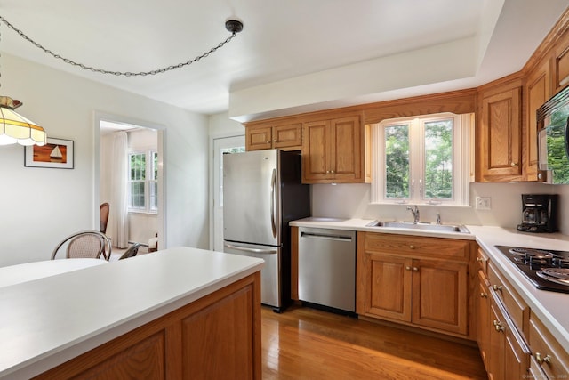 26 Wayfaring Rd, Norwalk, CT 06851 - kitchen featuring stainless steel appliances, light countertops, healthy amount of natural light, and wood finished floors