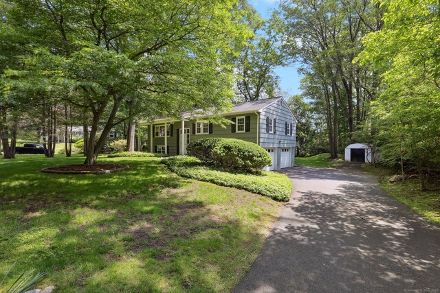 26 Wayfaring Rd, Norwalk, CT 06851 - split foyer home featuring a garage, driveway, and a front lawn