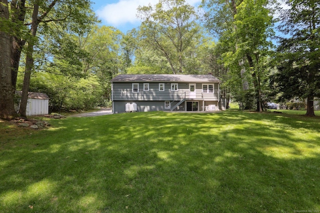 26 Wayfaring Rd, Norwalk, CT 06851 - rear view of house with stairway, a lawn, a wooden deck, and view of scattered trees