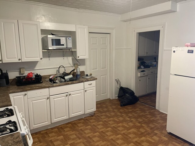 50 Beacon St, Waterbury, CT 06704 - kitchen with white appliances, white cabinetry, dark countertops, and crown molding
