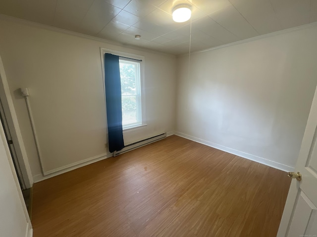 50 Beacon St, Waterbury, CT 06704 - unfurnished room with a baseboard radiator, ornamental molding, and wood finished floors