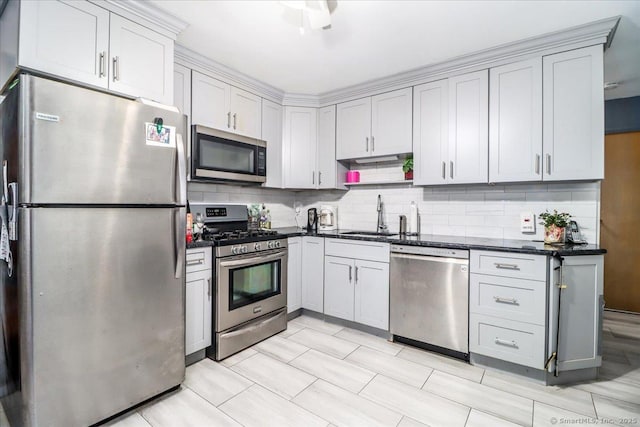 115 Sunburst Rd, Bridgeport, CT 06606 - kitchen with appliances with stainless steel finishes, tasteful backsplash, and dark stone counters