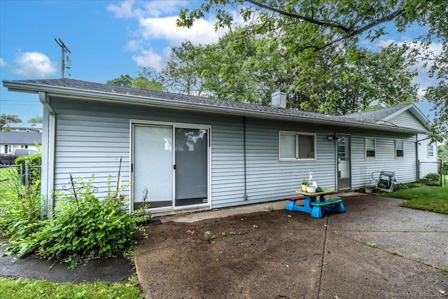 115 Sunburst Rd, Bridgeport, CT 06606 - rear view of property with a patio, a chimney, and roof with shingles