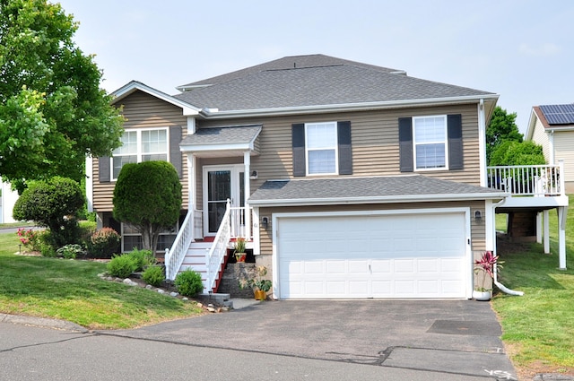 61 Windy Hill Ln Unit 61, Rocky Hill, CT 06067 - view of front facade featuring driveway, a garage, a front yard, and a shingled roof