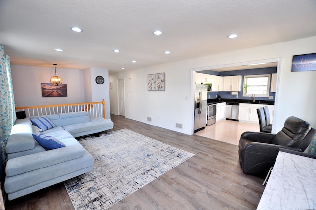 61 Windy Hill Ln Unit 61, Rocky Hill, CT 06067 - living room with recessed lighting, light wood finished floors, baseboards, and a chandelier