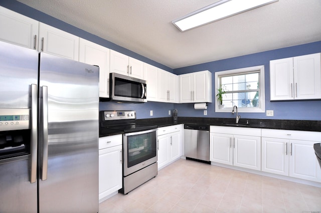 61 Windy Hill Ln Unit 61, Rocky Hill, CT 06067 - kitchen featuring appliances with stainless steel finishes, white cabinetry, a sink, and dark countertops