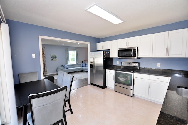 61 Windy Hill Ln Unit 61, Rocky Hill, CT 06067 - kitchen featuring stainless steel appliances, white cabinetry, dark stone countertops, and open floor plan