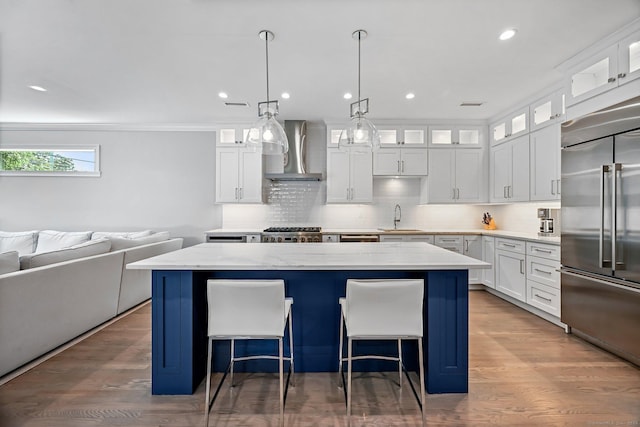 868 S Pine Creek Rd, Fairfield, CT 06824 - kitchen featuring stainless steel built in fridge, wall chimney range hood, a sink, a center island, and range