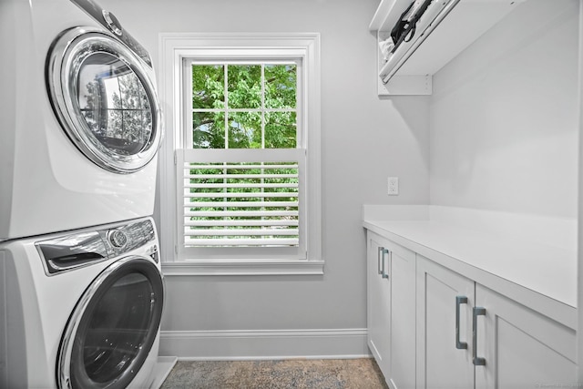 868 S Pine Creek Rd, Fairfield, CT 06824 - washroom featuring stacked washing machine and dryer, baseboards, and cabinet space