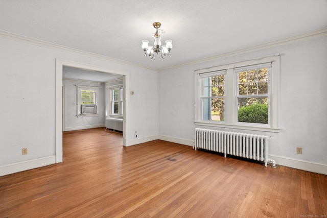 28 Wardwell Rd, West Hartford, CT 06107 - spare room featuring radiator, a chandelier, baseboards, light wood-style floors, and ornamental molding