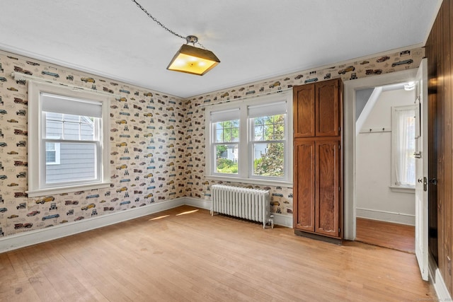 28 Wardwell Rd, West Hartford, CT 06107 - unfurnished room featuring radiator heating unit, light wood-style flooring, baseboards, and wallpapered walls