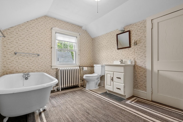28 Wardwell Rd, West Hartford, CT 06107 - bathroom featuring radiator heating unit, vanity, lofted ceiling, a freestanding tub, and toilet