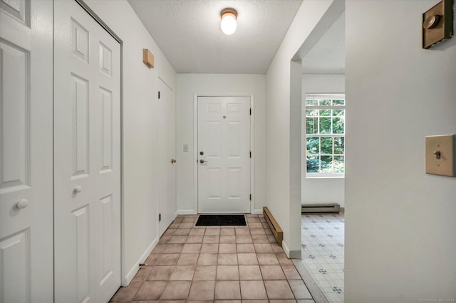 745 Merrow Rd Apt 157, Coventry, CT 06238 - foyer entrance with a textured ceiling, baseboards, and a baseboard heating unit