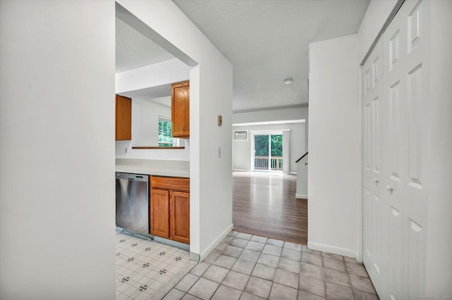 745 Merrow Rd Apt 157, Coventry, CT 06238 - kitchen with dishwasher, brown cabinetry, baseboards, light countertops, and a textured ceiling