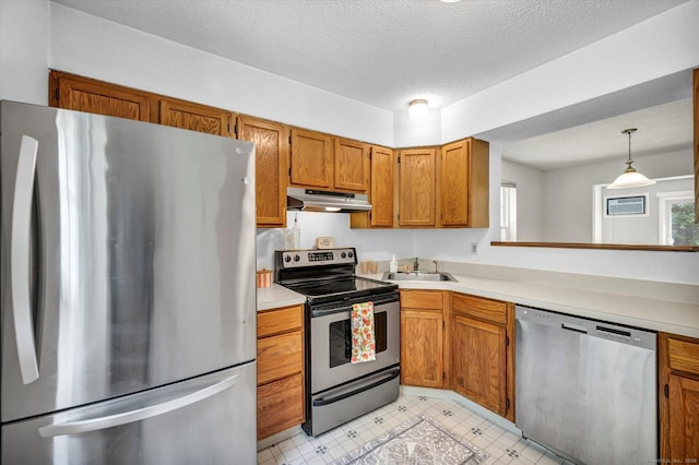 745 Merrow Rd Apt 157, Coventry, CT 06238 - kitchen with stainless steel appliances, under cabinet range hood, brown cabinets, light countertops, and a sink