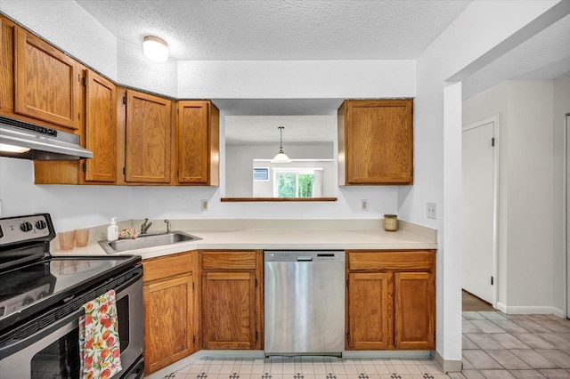 745 Merrow Rd Apt 157, Coventry, CT 06238 - kitchen with stainless steel appliances, under cabinet range hood, a sink, brown cabinets, and a textured ceiling