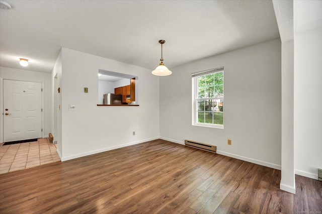 745 Merrow Rd Apt 157, Coventry, CT 06238 - spare room featuring a baseboard radiator, wood finished floors, baseboards, and a smoke detector