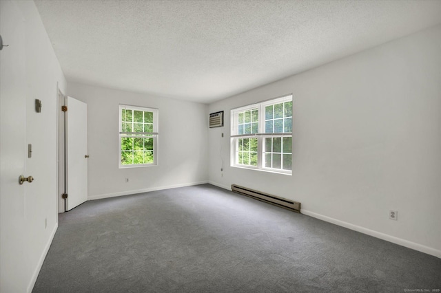 745 Merrow Rd Apt 157, Coventry, CT 06238 - unfurnished room featuring a baseboard heating unit, carpet flooring, a wall mounted AC, baseboards, and a textured ceiling