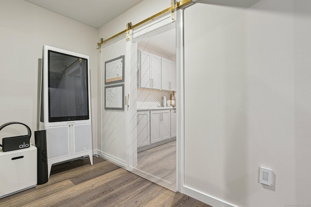 958 Essex Rd, Westbrook, CT 06498 - corridor with wood finished floors and a barn door
